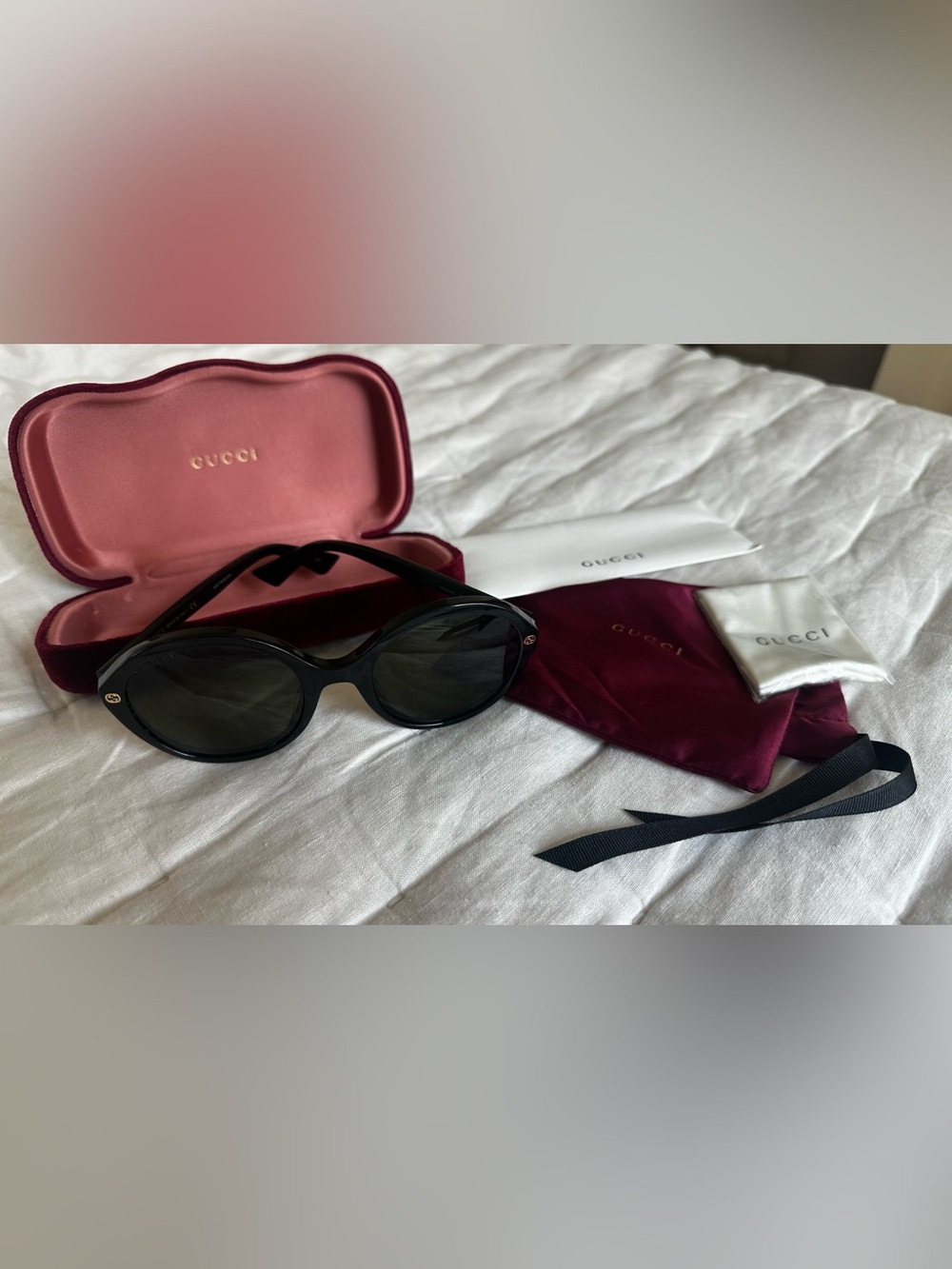 Gucci Black Oval Sunglasses with Dark Lenses